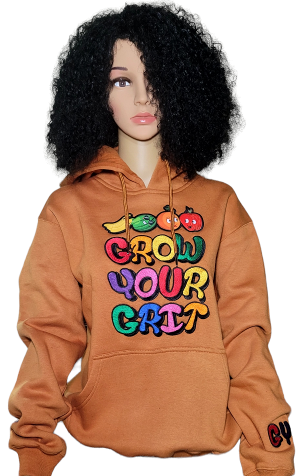 A woman wearing our signature caramel brown branded hoodie with embroidered grow your grit logo